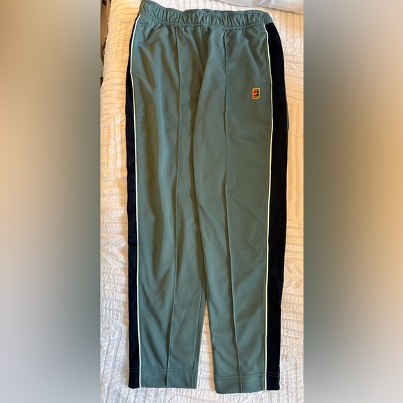 Nike greenish-teal pant with navy stripe and seafoam green piping. Men’s size M. - Picture 1 of 3